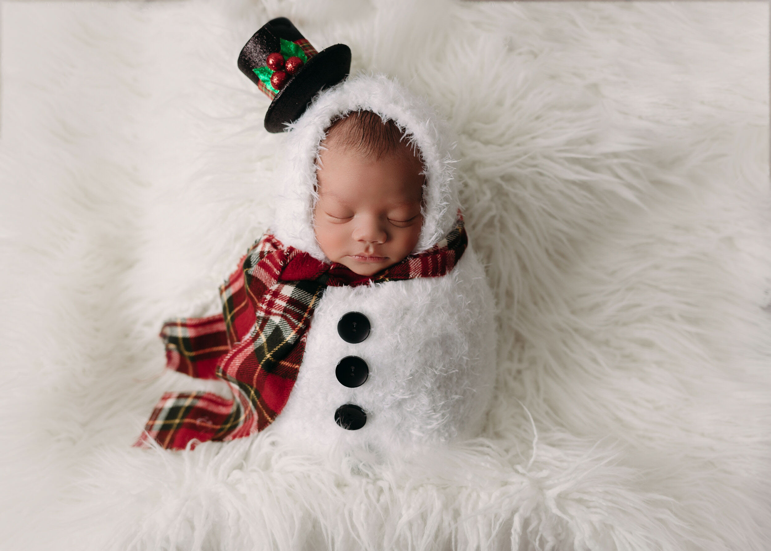 baby boy in snowman romper on flokati for christmas newborn session in minneapolis mn