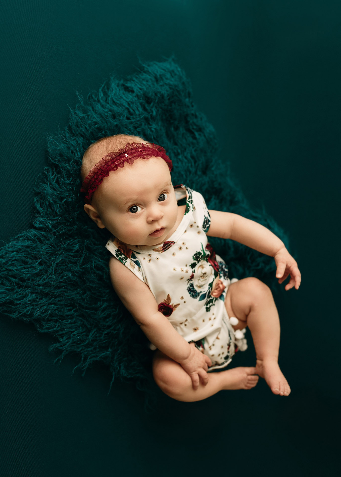 4 month milestone baby girl on emerald with floral romper