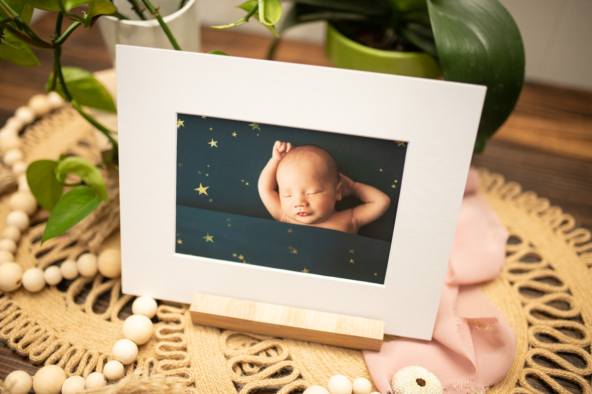 folio mat print of baby boy tucked in on teal with stars kona Hawaii big island newborn photographer